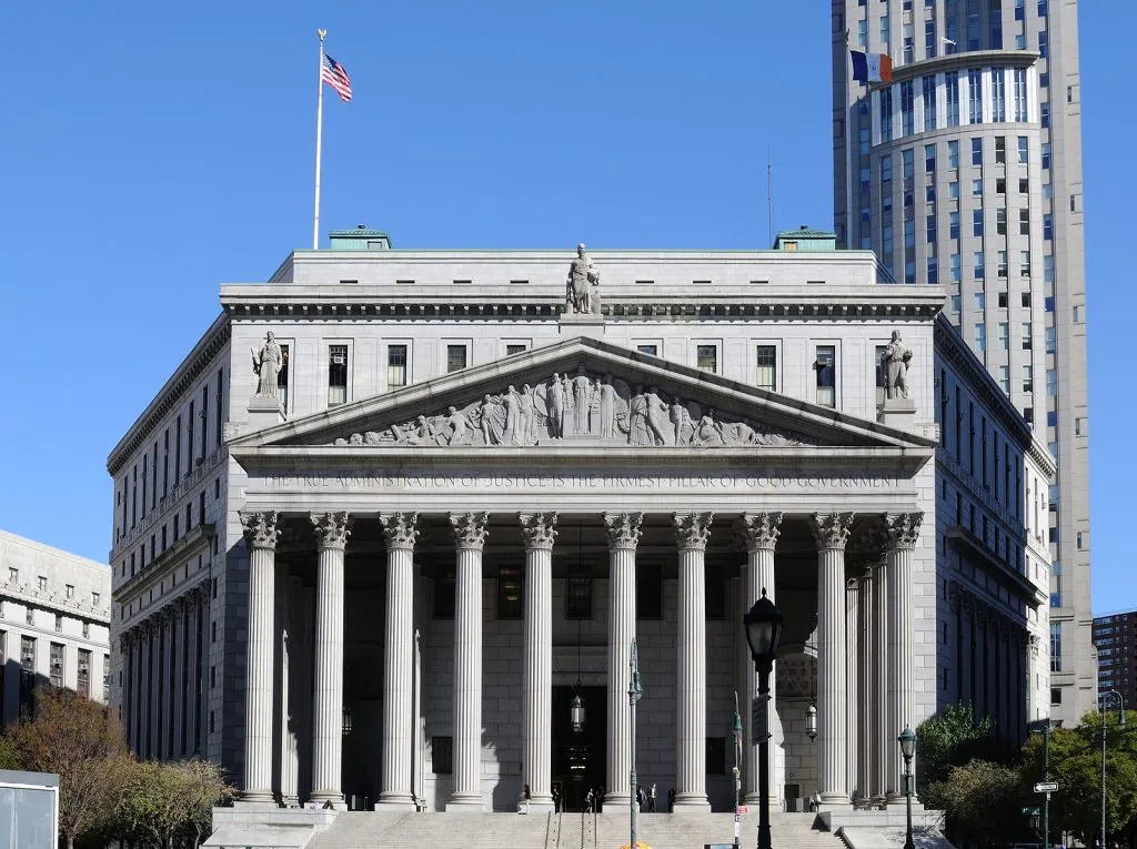 Historic New York courthouse with classical columns under a blue sky